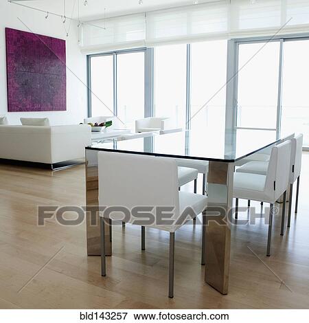 Dining table, chairs and sofa in modern living space View Large Photo Image Stock Photo - Dining table, chairs and sofa in modern living space. Fotosearch