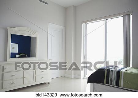 Dresser, mirror and windows in modern bedroom View Large Photo Image Stock Photo - Dresser, mirror and windows in modern bedroom. Fotosearch