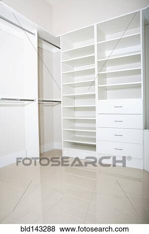 Empty shelves and drawers in modern walk-in closet View Large Photo Image Stock Photo - Empty shelves and drawers in modern walk-in closet. Fotosearch