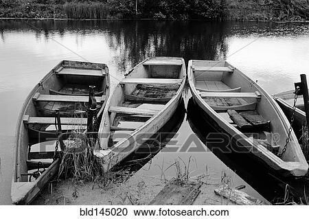 Empty wooden canoes on river View Large Photo Image Stock Image - Empty wooden canoes on river. Fotosearch
