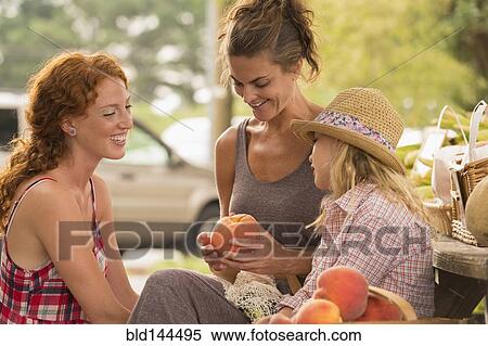 Family browsing produce at farmers market View Large Photo Image Stock Photography - Family browsing produce at farmers market. Fotosearch