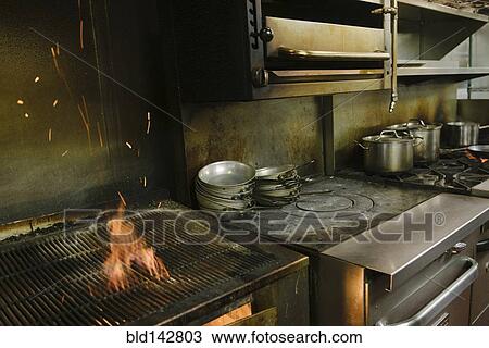 Flaming grill in restaurant kitchen View Large Photo Image Stock Image - Flaming grill in restaurant kitchen. Fotosearch