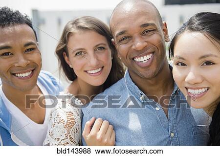 Stock Photo - Friends smiling at party. Fotosearch