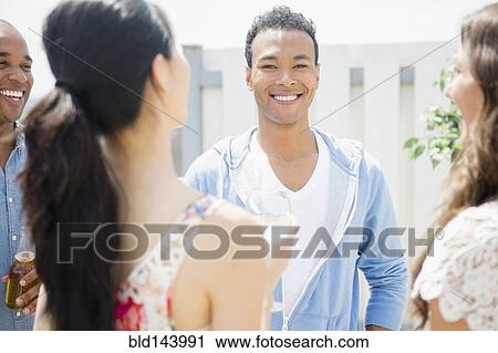 Friends talking at party View Large Photo Image Stock Image - Friends talking at party. Fotosearch