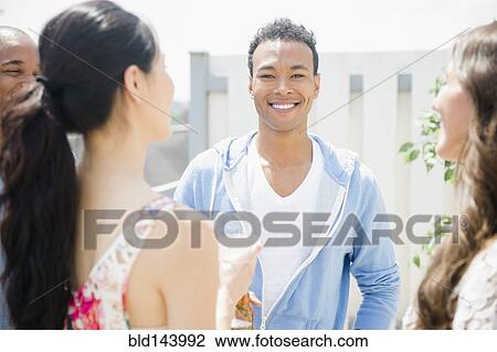 Friends talking at party View Large Photo Image Stock Image - Friends talking at party. Fotosearch