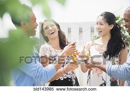 Stock Photography - Friends toasting each other at party. Fotosearch