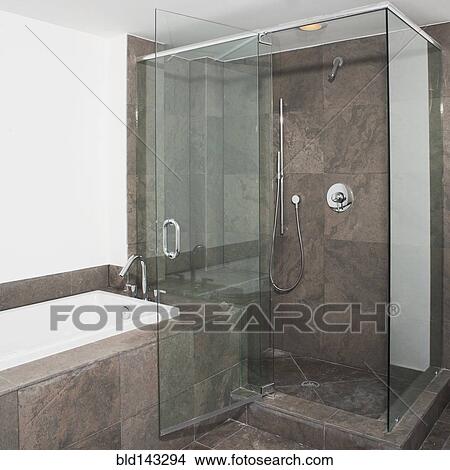 Glass doors of shower and bathtub in modern bathroom View Large Photo Image Picture - Glass doors of shower and bathtub in modern bathroom. Fotosearch
