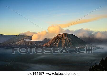High angle view of clouds under smoking volcano View Large Photo Image Stock Photo - High angle view of clouds under smoking volcano. Fotosearch