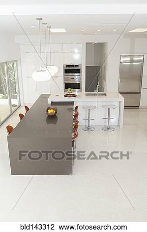 Stock Image - High angle view of counters in modern kitchen and dining area. Fotosearch