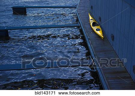 Stock Image - High angle view of kayak on wooden dock. Fotosearch