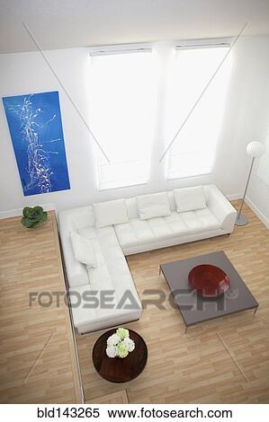 Stock Photography - High angle view of sofas and coffee table in modern living room. Fotosearch