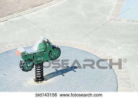 Stock Photograph - High angle view of toy motorcycle at playground. Fotosearch