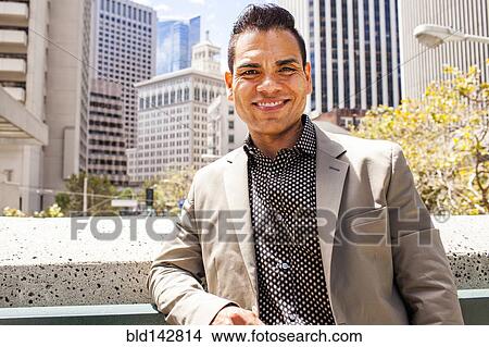 Hispanic businessman smiling in city, View Large Photo Image Picture - Hispanic businessman smiling in city, . Fotosearch