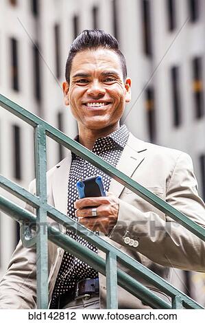 Hispanic businessman smiling outdoors View Large Photo Image Stock Image - Hispanic businessman smiling outdoors. Fotosearch