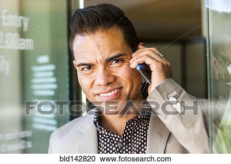 Hispanic businessman talking on cell phone in doorway View Large Photo Image Stock Image - Hispanic businessman talking on cell phone in doorway. Fotosearch