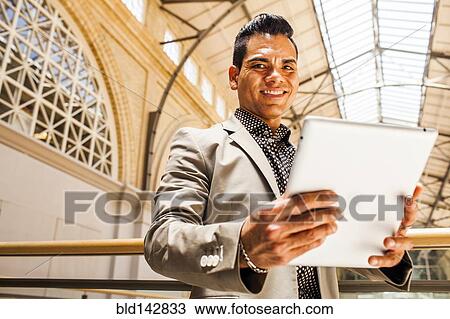 Hispanic businessman using digital tablet View Large Photo Image Stock Image - Hispanic businessman using digital tablet. Fotosearch