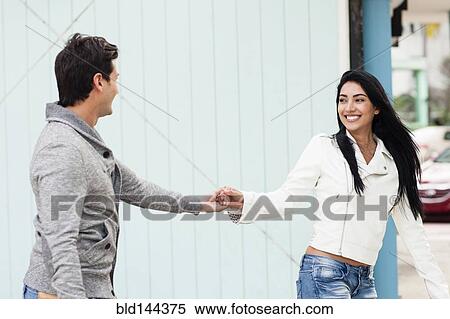 Hispanic couple holding hands outdoors View Large Photo Image Stock Photography - Hispanic couple holding hands outdoors. Fotosearch