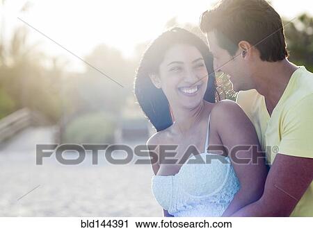 Hispanic couple hugging on beach View Large Photo Image Stock Image - Hispanic couple hugging on beach. Fotosearch
