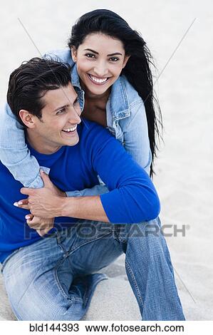 Hispanic couple hugging on beach View Large Photo Image Stock Image - Hispanic couple hugging on beach. Fotosearch