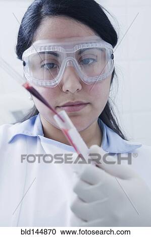 Hispanic scientist pipetting blood sample View Large Photo Image Stock Image - Hispanic scientist pipetting blood sample. Fotosearch