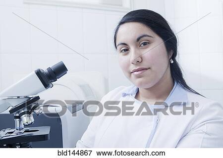 Stock Photo - Hispanic scientist smiling in laboratory. Fotosearch