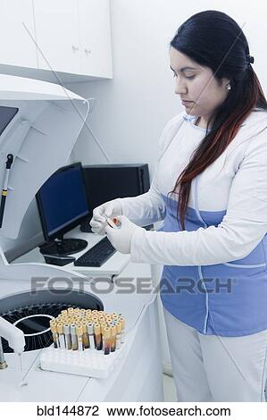Hispanic scientist testing blood sample in laboratory centrifuge View Large Photo Image Stock Image - Hispanic scientist testing blood sample in laboratory centrifuge. Fotosearch