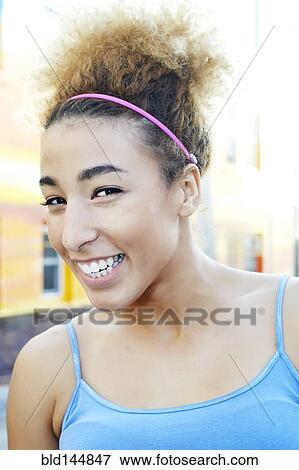 Stock Photo - Hispanic woman smiling outdoors. Fotosearch