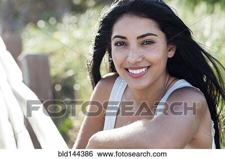 Hispanic woman smiling outdoors View Large Photo Image Stock Photograph - Hispanic woman smiling outdoors. Fotosearch