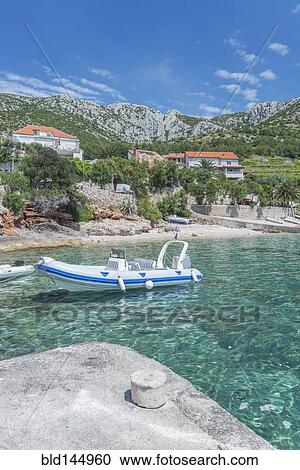 Inflatable boat in lake in remote landscape View Large Photo Image Stock Image - Inflatable boat in lake in remote landscape. Fotosearch
