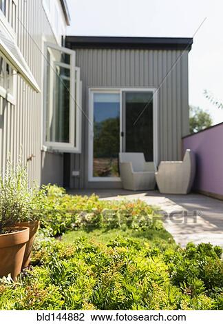 Landscaping and patio of modern condo building View Large Photo Image Stock Image - Landscaping and patio of modern condo building. Fotosearch