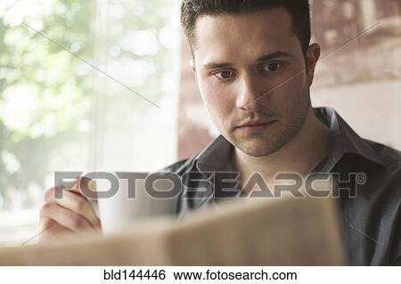 Man drinking cup of coffee and reading newspaper View Large Photo Image Stock Photograph - Man drinking cup of coffee and reading newspaper. Fotosearch
