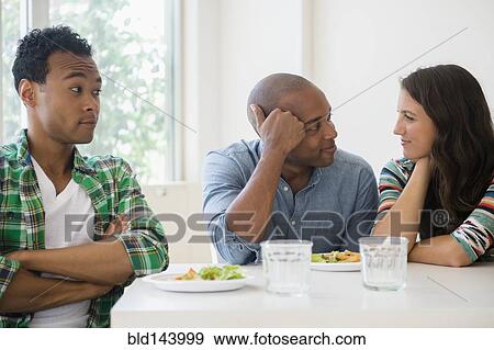 Stock Photo - Man surprised at friends flirting. Fotosearch