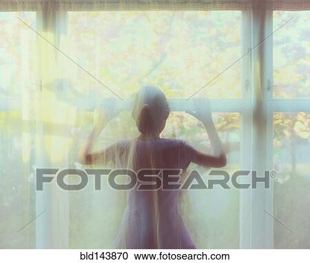 Mixed race girl standing behind sheer curtain in window View Large Photo Image Stock Image - Mixed race girl standing behind sheer curtain in window. Fotosearch