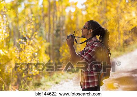 Mixed race hiker taking photograph in forest View Large Photo Image Stock Image - Mixed race hiker taking photograph in forest. Fotosearch