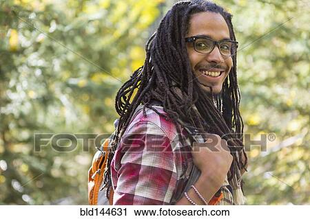 Mixed race man hiking in forest View Large Photo Image Stock Image - Mixed race man hiking in forest. Fotosearch