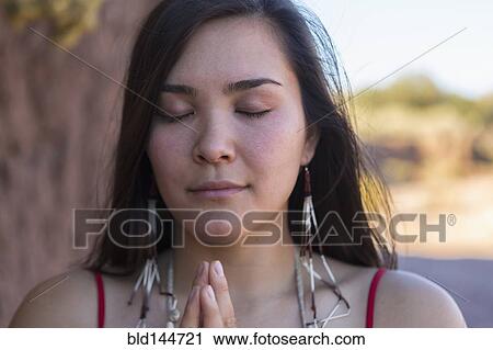 Mixed race woman praying in desert View Large Photo Image Stock Image - Mixed race woman praying in desert. Fotosearch