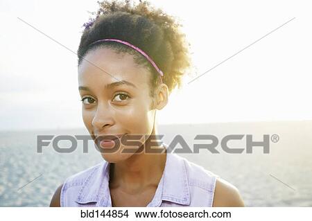 Mixed race woman smiling at beach View Large Photo Image Picture - Mixed race woman smiling at beach. Fotosearch