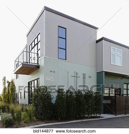 Stock Photo - Modern condo building and parking lot. Fotosearch