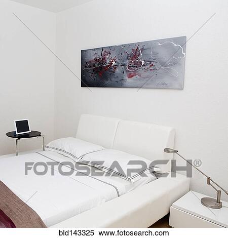 Night table, wall art and bed in modern bedroom View Large Photo Image Stock Photography - Night table, wall art and bed in modern bedroom. Fotosearch