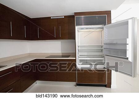 Open refrigerator in empty kitchen View Large Photo Image Stock Image - Open refrigerator in empty kitchen. Fotosearch