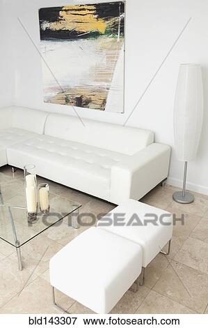 Stock Photo - Ottomans, coffee table and sofa in modern living room. Fotosearch