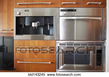 Stock Photography - Ovens, microwave and cabinets in modern kitchen. Fotosearch