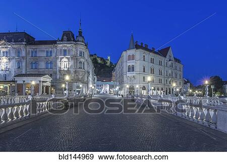 Pedestrian bridge and buildings illuminated at night, Ljubljana, Central Slovenia, Slovenia View Large Photo Image Stock Photo - Pedestrian bridge and buildings illuminated at night, Ljubljana, Central Slovenia, Slovenia. Fotosearch