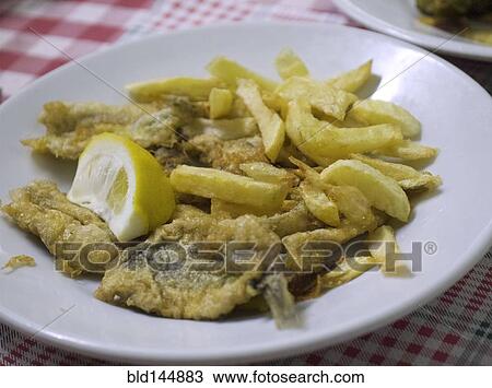 Stock Image - Plate of fried fish and french fries with lemon. Fotosearch