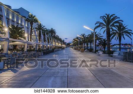 Promenade, buildings and city sidewalk at dusk, Split, Split, Croatia View Large Photo Image Stock Photo - Promenade, buildings and city sidewalk at dusk, Split, Split, Croatia. Fotosearch