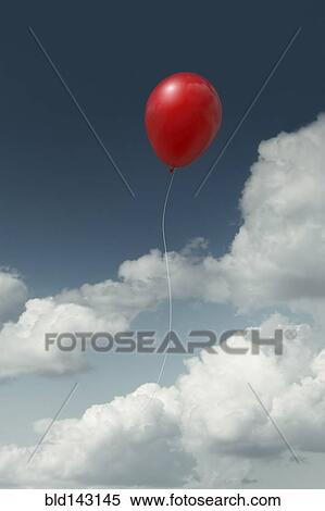 Stock Photography - Red balloon floating in cloudy sky. Fotosearch