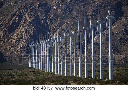 Row of wind turbines in rocky remote landscape View Large Photo Image Stock Photo - Row of wind turbines in rocky remote landscape. Fotosearch