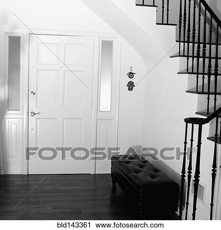 Settee, front door and staircase in modern entryway View Large Photo Image Stock Image - Settee, front door and staircase in modern entryway. Fotosearch