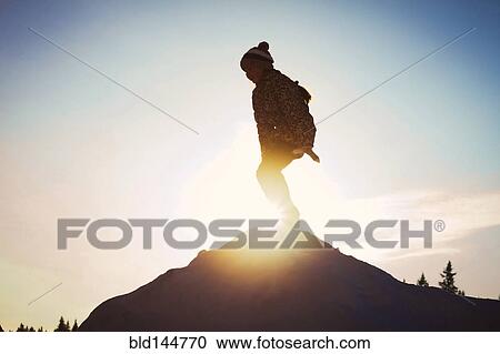 Silhouette of Caucasian child on mountaintop View Large Photo Image Stock Image - Silhouette of Caucasian child on mountaintop. Fotosearch