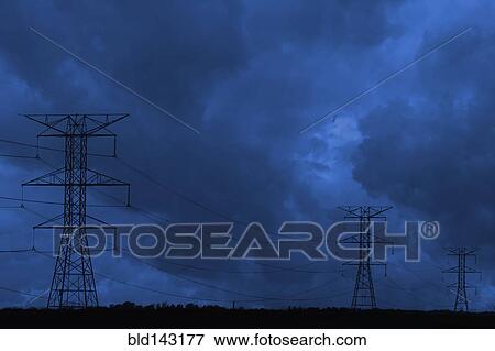 Silhouette of power lines under dark cloudy sky View Large Photo Image Stock Photo - Silhouette of power lines under dark cloudy sky. Fotosearch